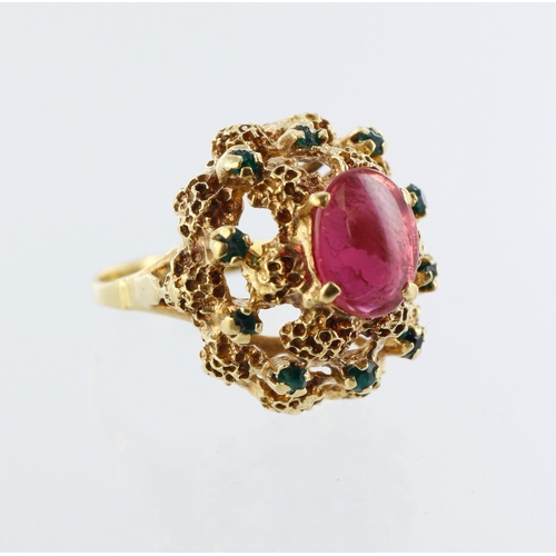 87 - Yellow metal dress ring, centre ruby cabochon, ten round emerald points, finger size L/M, weight 7.3... 