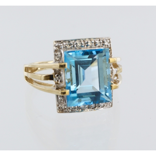 93 - 9ct yellow gold blue topaz and diamond dress ring, 12mm x 10mm blue topaz, eighteen round single cut... 