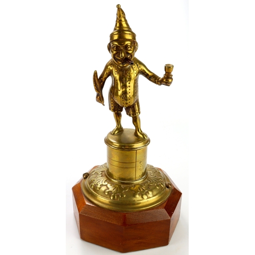 418 - Brass Mr Punch table / counter lighter, mounted on an octagonal plinth, total height 24cm approx.