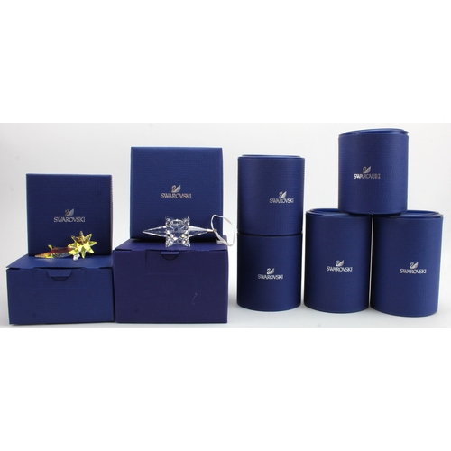 79 - Swarovski. A collection of nine boxed Swarovski crystal star ornaments, largest diameter 10cm approx... 