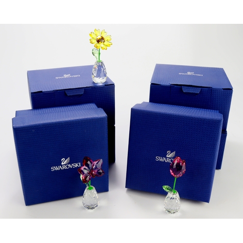 80 - Swarovski. A collection of seven boxed Swarovski crystal flower dreams ornaments, tallest 70mm appro... 