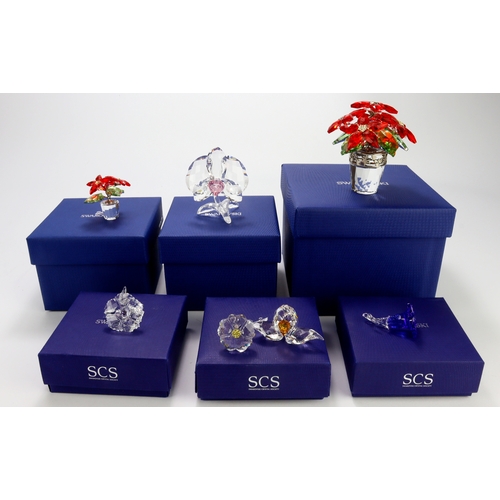 81 - Swarovski. A collection of seven boxed Swarovski crystal flower ornaments, including a large Poinset... 