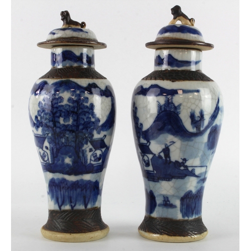 92 - Vases. Two blue & white Chinese lidded vases, both with crackle effect to the glaze, marks to base o... 