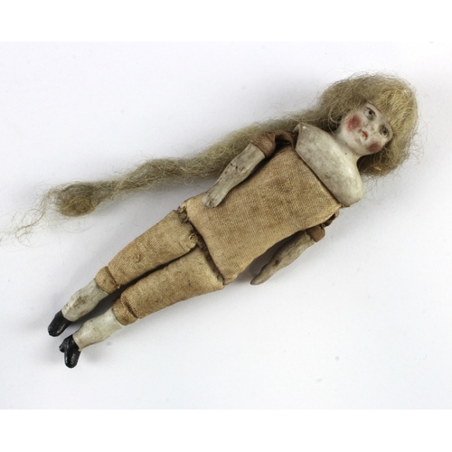 96 - 19th Century miniature bisque doll with real hair. Approx 13cm long