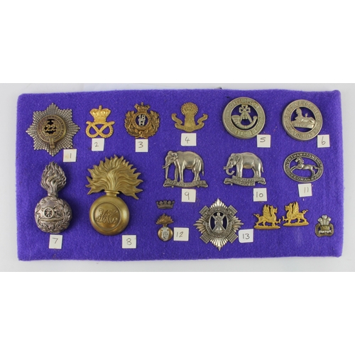 368 - Military Badge collection mostly QV crown mounted on purple board, incl Helmet Plate centres, Glenga... 