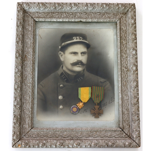 676 - France a WW1 Bravery medal pair framed with soldiers portrait.