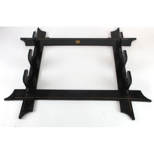 94 - Japanese c19th century blackened sword stand for 3 swords, with wall fittings