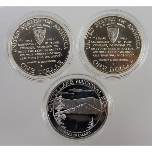 975 - USA (3) D-Day silver Dollars 1995 x2 UNC in capsules, along with a Greater Lake National Park white ... 