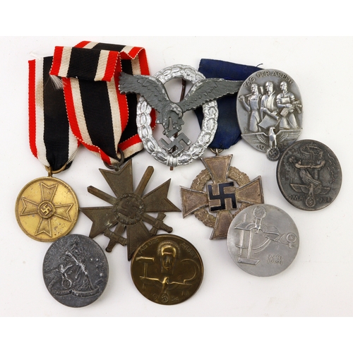 904 - German WW2 badges and medals nine items.