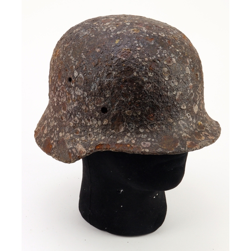 933 - German WW2 relic helmet with shrapnel damage with its original white pain finish and traces of a dec... 