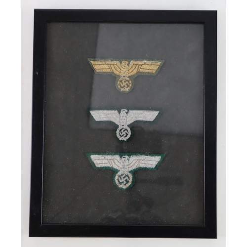 729 - German framed sets of three officers breast eagles in frame, two sets.