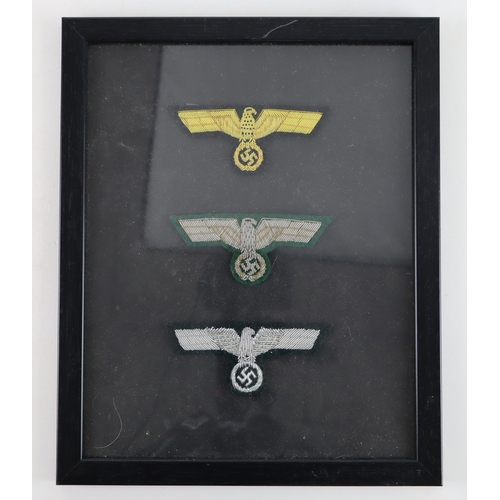 729 - German framed sets of three officers breast eagles in frame, two sets.