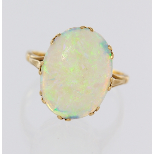 73 - Yellow metal (tests 18ct) opal ring, oval opal cabochon approx. 17mm x 13mm in multi claw mount, fin... 