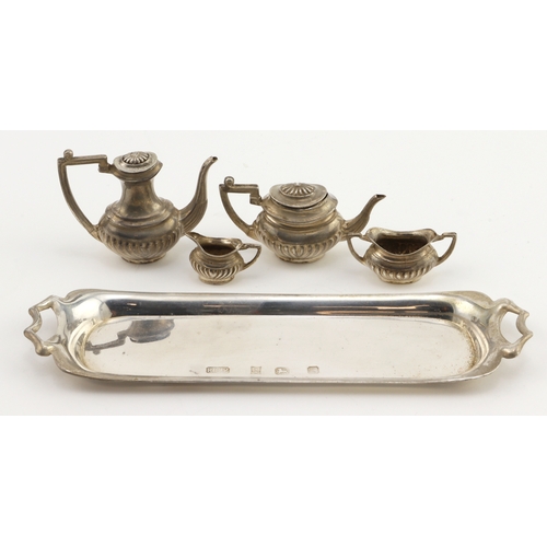 750 - Silver. A miniature silver tea set, comprising teapot coffee pot, sugar bowl, milk jug & tray, hallm... 