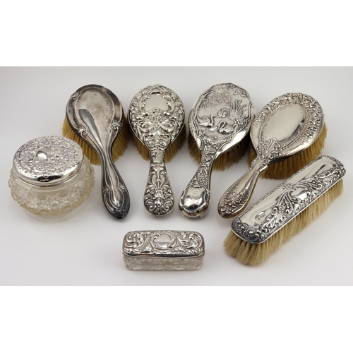 757 - Vanity items. A collection of eight silver vanity items, comprising five silver mounted brushes, two... 