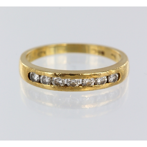 84 - Yellow metal (tests 18ct) diamond channel set half eternity ring, seven round brilliant cuts, total ... 