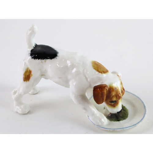 129 - Four Royal Doulton china dogs HN1159 Dog with bone, HN1098 Dog on floor, HN1156 Dog eating from a pl... 