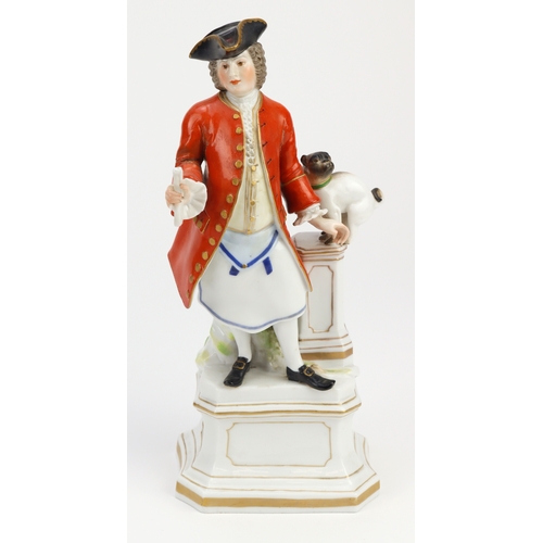 88 - Masonic interest. A porcelain figure depicting a Free Mason wearing an apron stood next to a pedesta... 