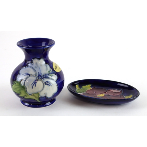 95 - Moorcroft. A small Moorcroft vase, height 9.5cm approx., together with a small Moorcroft dish, lengt... 