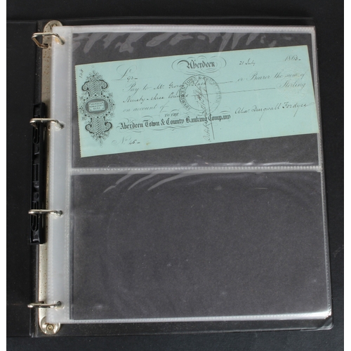30 - Cheques (73), a collection of Scottish cheques in an album, comprising Aberdeen Town & County Bankin... 