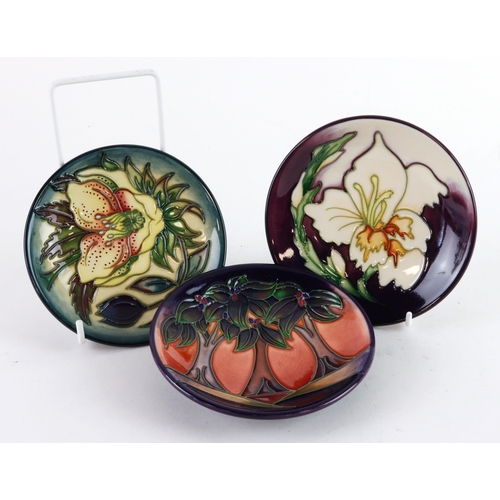111 - Moorcroft. Three Moorcroft pin dishes (various patterns), makers marks to base of each, diameter 12c... 