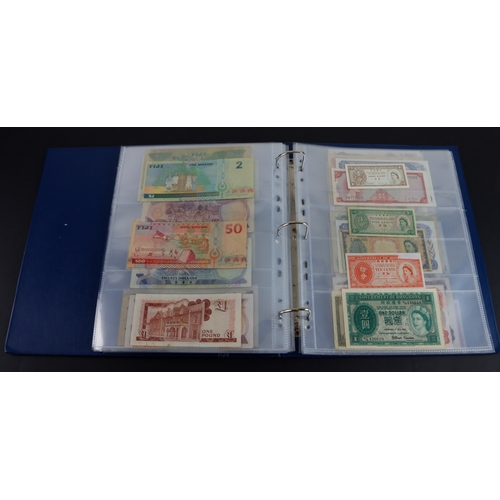 454 - British Commonwealth (90), a good group of Queen Elizabeth II portrait notes in an album, Bahamas (1... 