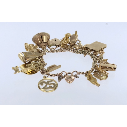 254 - 9ct/tests 9ct charm bracelet with a good assortment of mixed charms attached. Total weight 58.8g