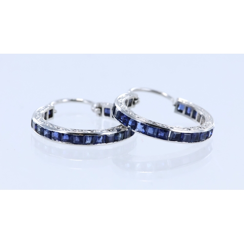 278 - White metal (tests platinum) sapphire hoop earrings, each earring set with twenty two princess cut s... 