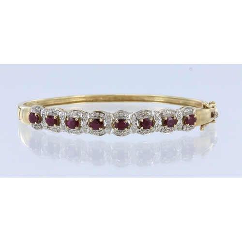 281 - Yellow metal (tests 14ct) ruby and diamond cluster hinged bangle with box clasp and double safety ca... 