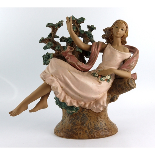 76 - Lladro. A large Lladro figure 'Day Dream', depicting a woman reclined amongst tree branches, height ... 