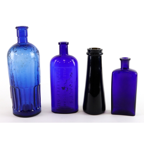 90 - Mixed lot of four coloured Glass Bottles, comprising a large blue glass poison bottle, a plain dark ... 