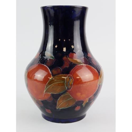 97 - Moorcroft 'Pomegranate' pattern vase, makers marks and signed to base, hairline crack to base, heigh... 