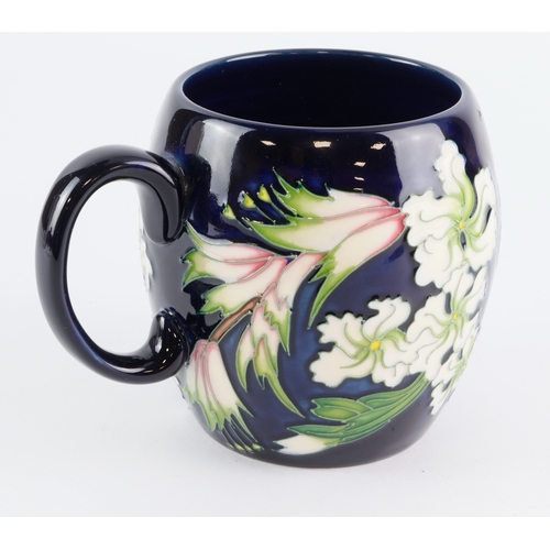99 - Moorcroft. Barrel mug with floral design, made for RHS Tatton, height 9cm approx. Stamped to base. 1... 