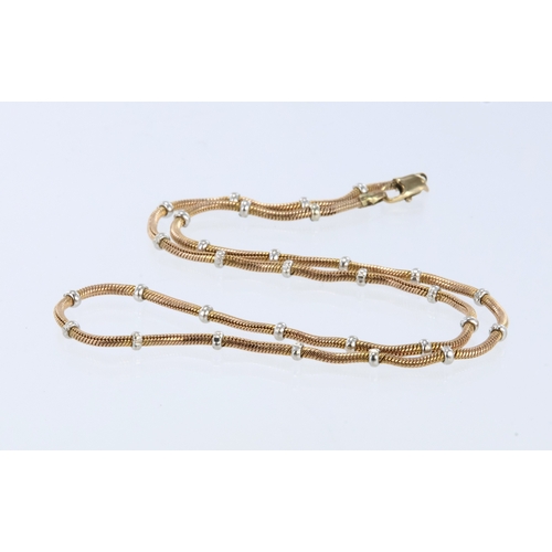 304 - 9ct gold two-tone necklace, the fine snake link chain spaced with small white metal beads, lobster c... 