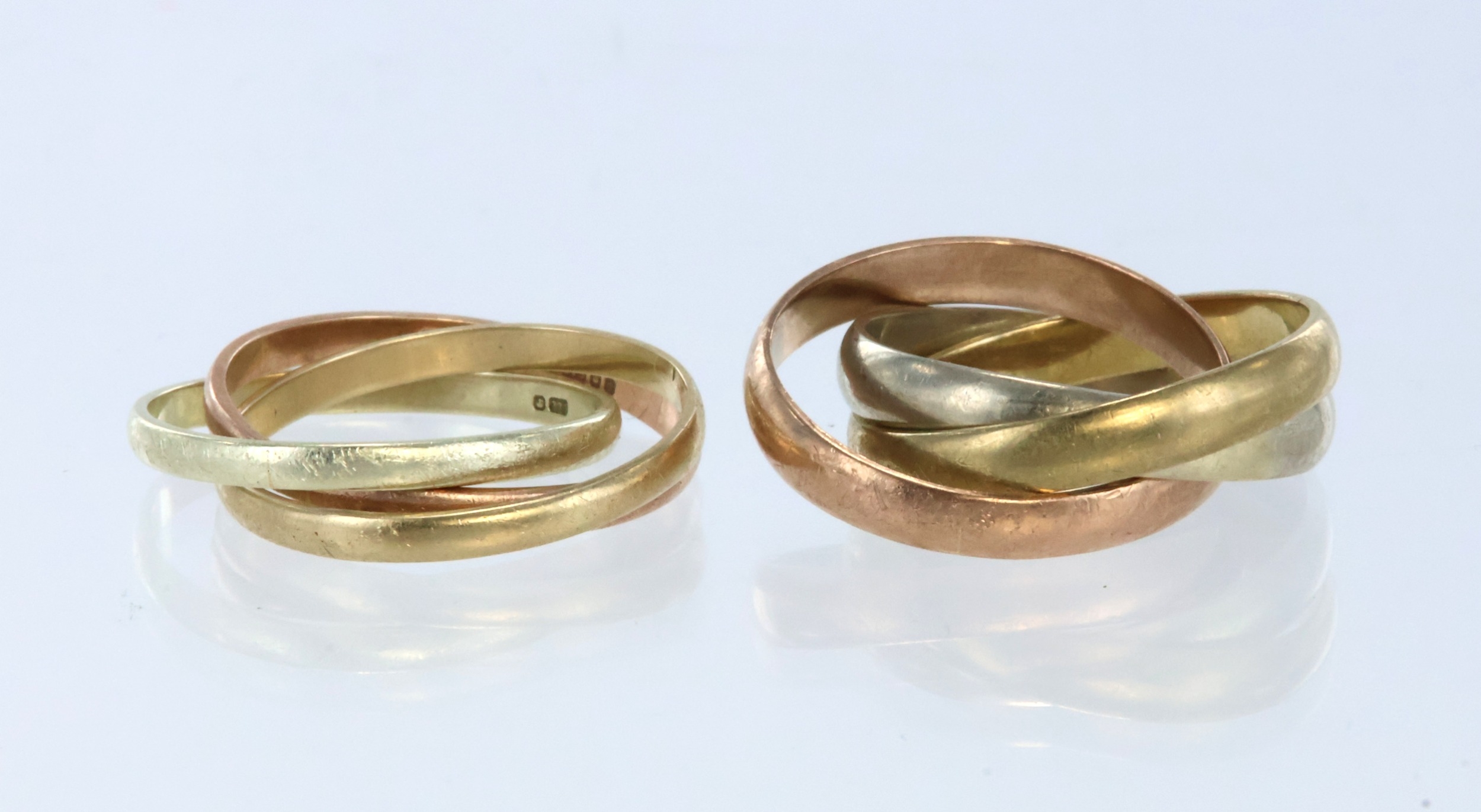 Two 9ct gold Russian wedding rings, each formed of three interlocking ...