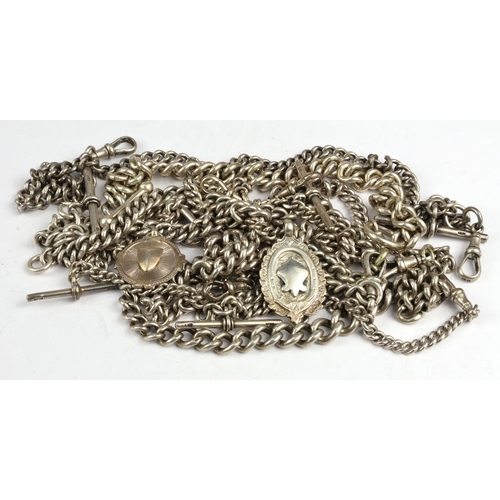 2 - Silver Albert chains (7), each of curb links, attached a variety of dog-clips, T-bars and fobs, gros... 