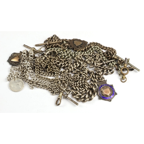 8 - Silver Albert chains (7), each of curb links, attached a variety of dog-clips, T-bars and fobs, gros... 