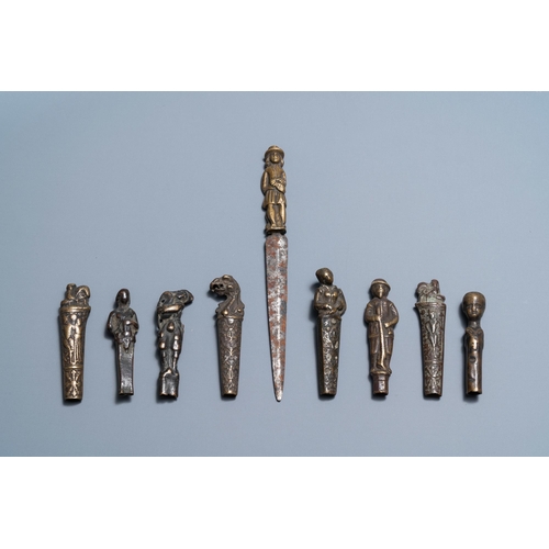 129 - Nine bronze and brass knife handles including one with a knife, 16/18th C.L.: 19 cm (the knife with ... 