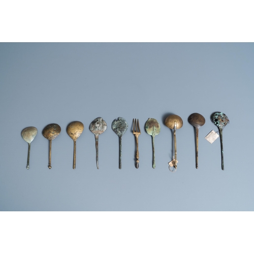 130 - Nine brass spoons and a small fork, 15/16th C.L.: 17,5 cm (the largest)  One with a label: found in ... 