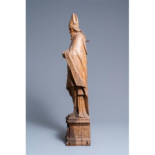 149 - A large oak figure of a bishop on a reliquary base, Flanders, 18th C.H.: 85 cm  Provenance: - The Da... 