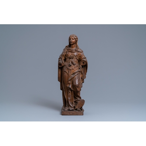 176 - An oak figure of a female saint crushing a griffin, 2nd half 16th C.H.: 55 cm  Provenance: - The Dav... 