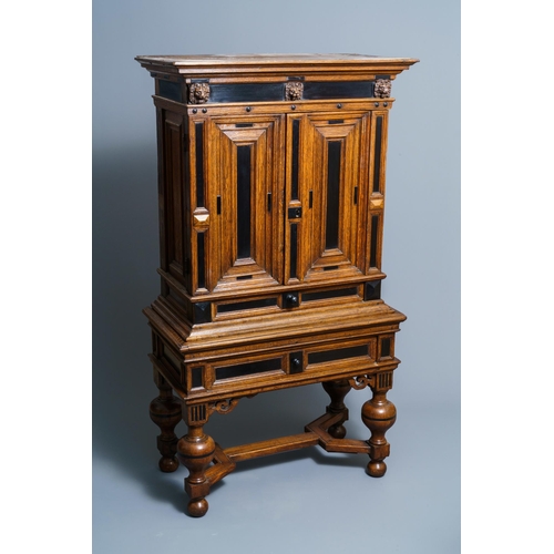 20 - An oak and ebony two-door cabinet, The Low Countries, 17th C.Dim.: 160,5 x 90 x 47 cm  Provenance: -... 