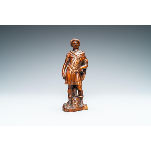 521 - A boxwood figure of David with the head of Goliath, Flanders, 17th C.H.: 29,5 cm (incl. stand)H.: 18... 