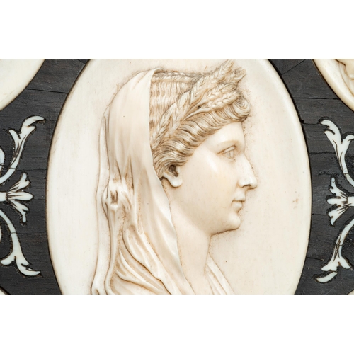 68 - Five ivory portrait medallions set in a pewter-mounted ebony frame, France and/or Italy, 19th C.Lot ... 