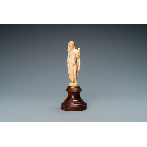 90 - An ivory figure of a woman dressed after the antique holding a vase, probably Dieppe, France, 19th C... 