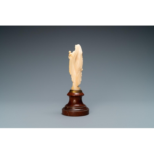 90 - An ivory figure of a woman dressed after the antique holding a vase, probably Dieppe, France, 19th C... 