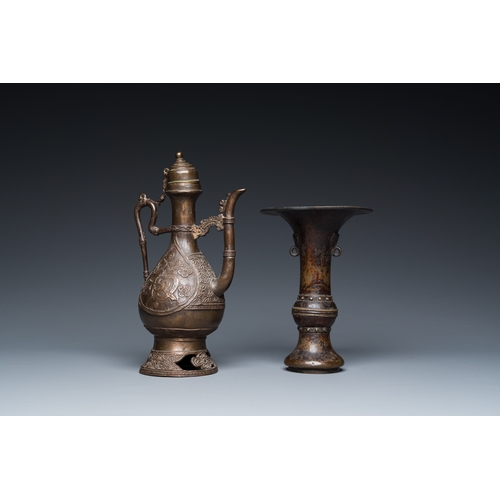 1098 - A Chinese bronze 'gu' vase and an Islamic market bronze ewer and cover, MingH.: 23,5 cm (the Islamic... 