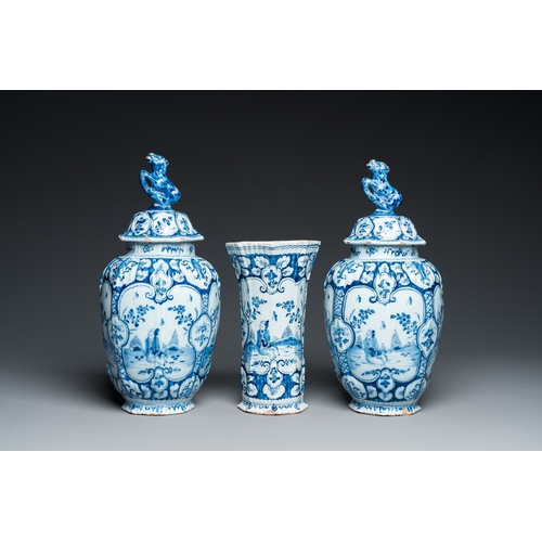 1308 - A Dutch Delft blue and white chinoiserie garniture of three vases, 18th C.H.: 34 cm (the tallest)... 