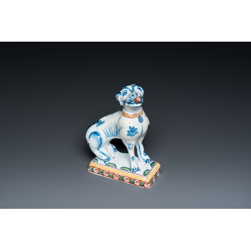 1322 - A polychrome Dutch Delft dog seated on a plinth, 18th C.H.: 12 cm
 
 Provenance:- A private collecti... 