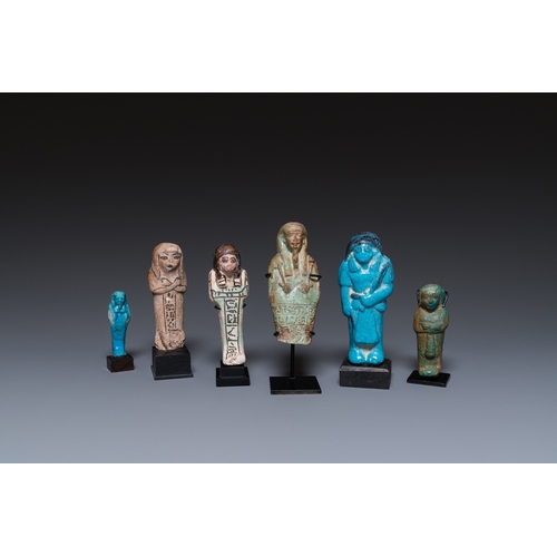 1401 - Six Egyptian green- and turquoise-glazed frit ushabtis, Late PeriodH.: 17 cm (the tallest incl. stan... 